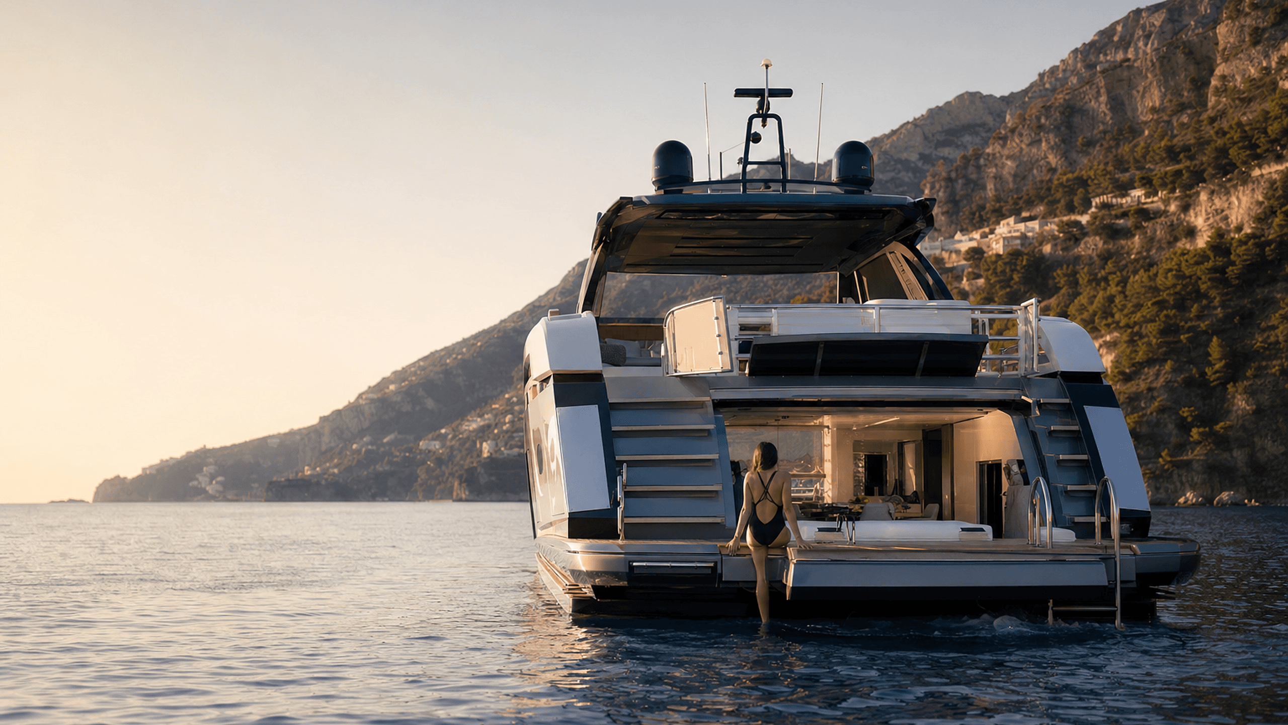 Superyachts moored side by side at golden hour